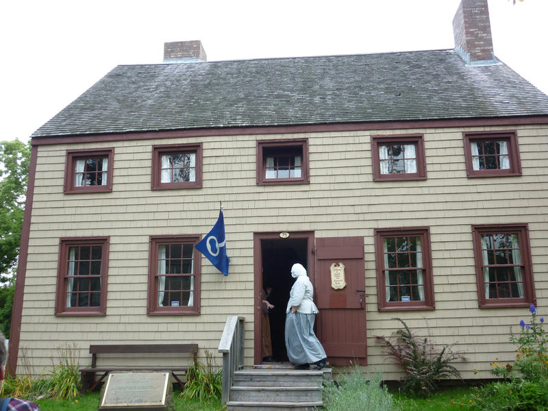 The facade of the Cossit House Museum of Nova Scotia, built in 1787, with woman dress in costume of the era